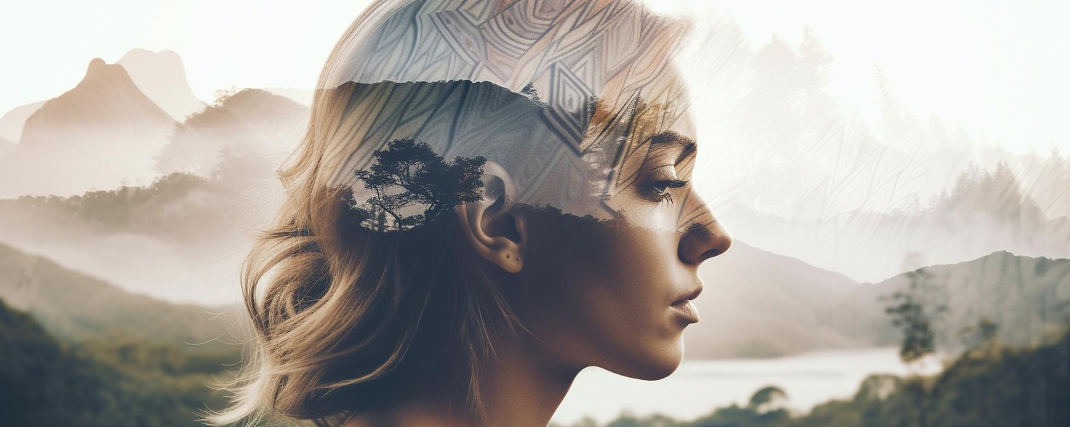 Woman’s profile blended with a mountain and forest landscape